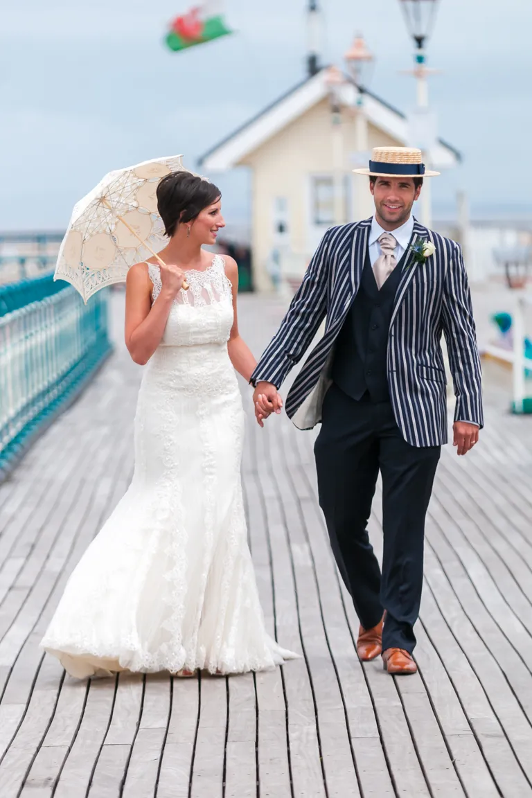 Wedding photographer Andrew Hazard bride & groom Penarth Pier