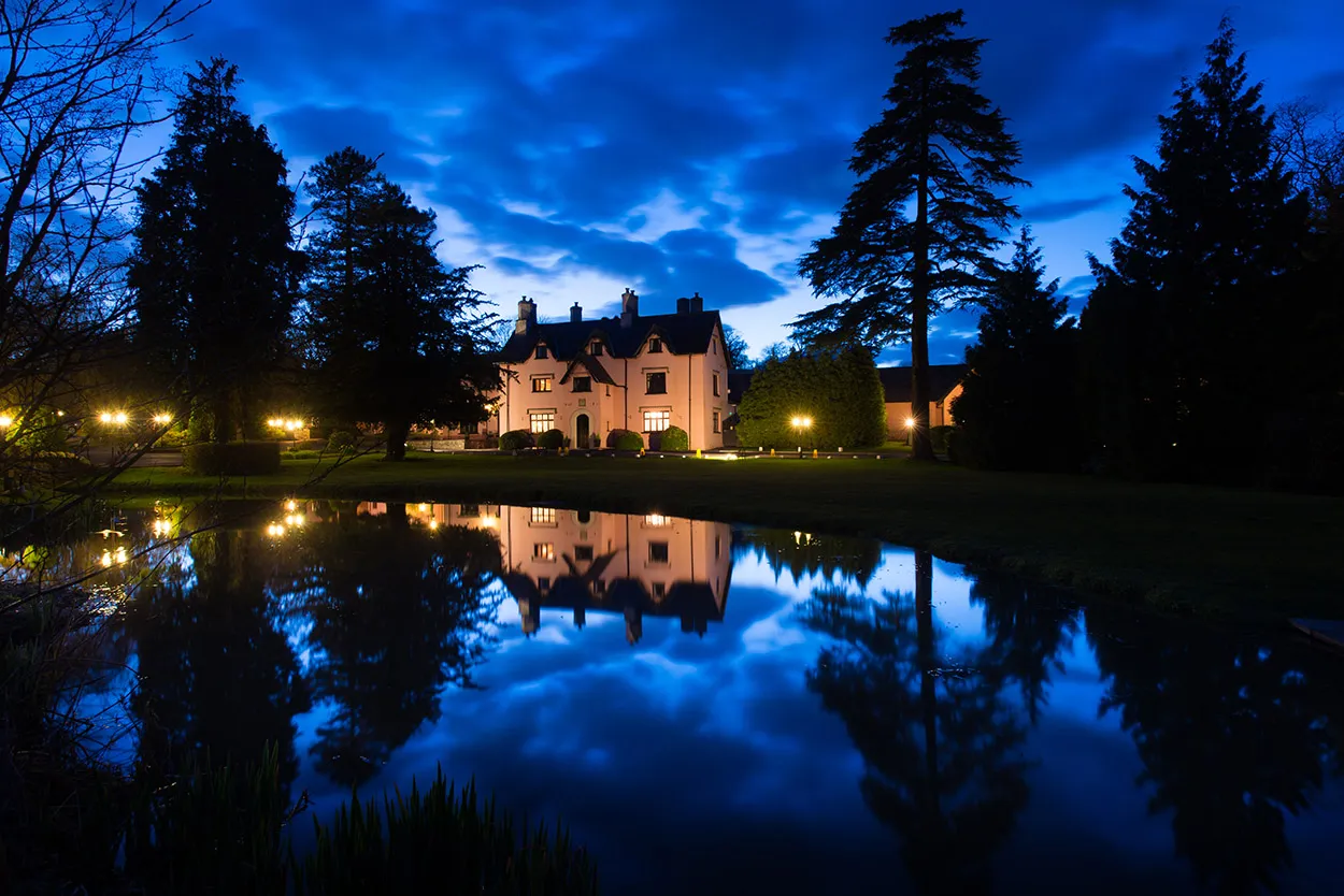 Cwrt Bleddyn Hotel at night reflection in pond
