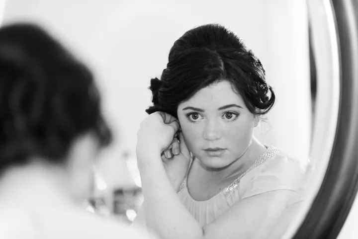 bridesmaid looking in mirror at St Pierre by Andrew Hazard Photography
