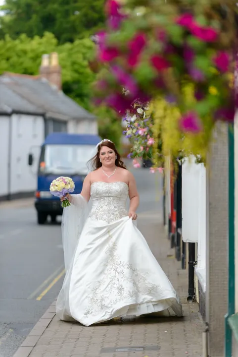 bride walking through Usk by Andrew Hazard