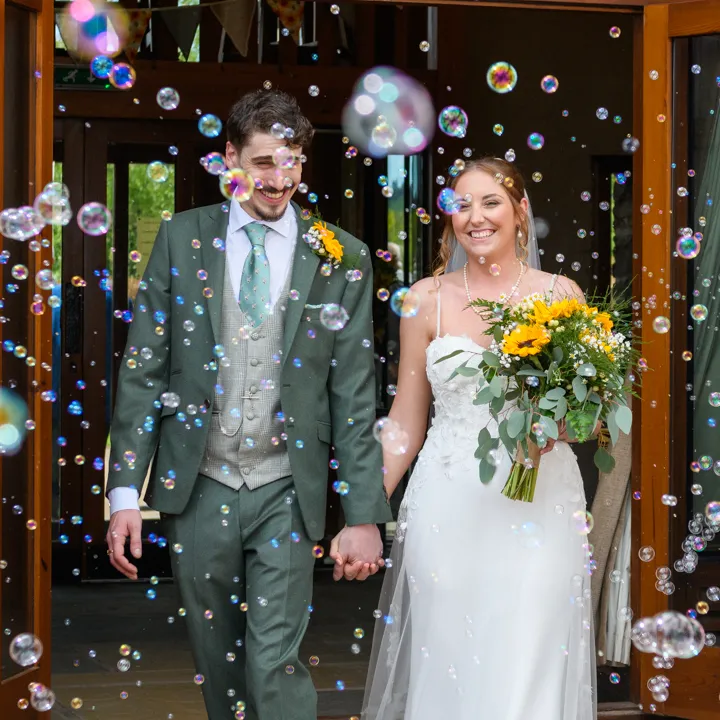 bride and groom and confetti at a wedding at The Barn at Brynich by Andrew Hazard Photography