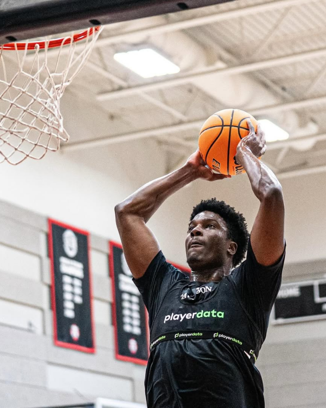 Basketball player shooting while wearing PlayerData vest