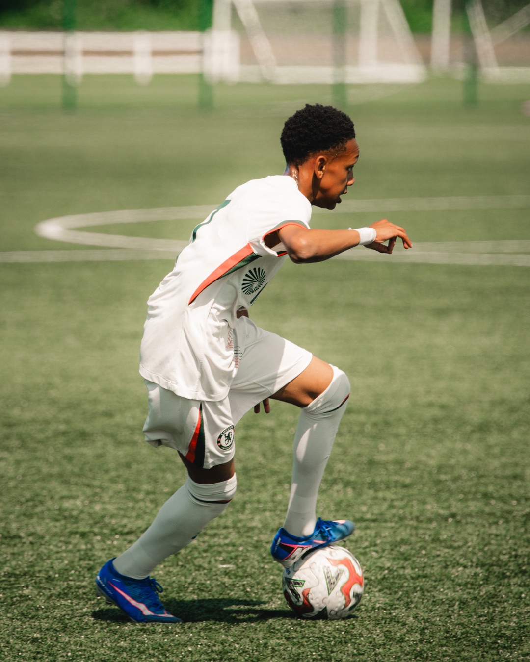 Youth academy player driving forward on the ball