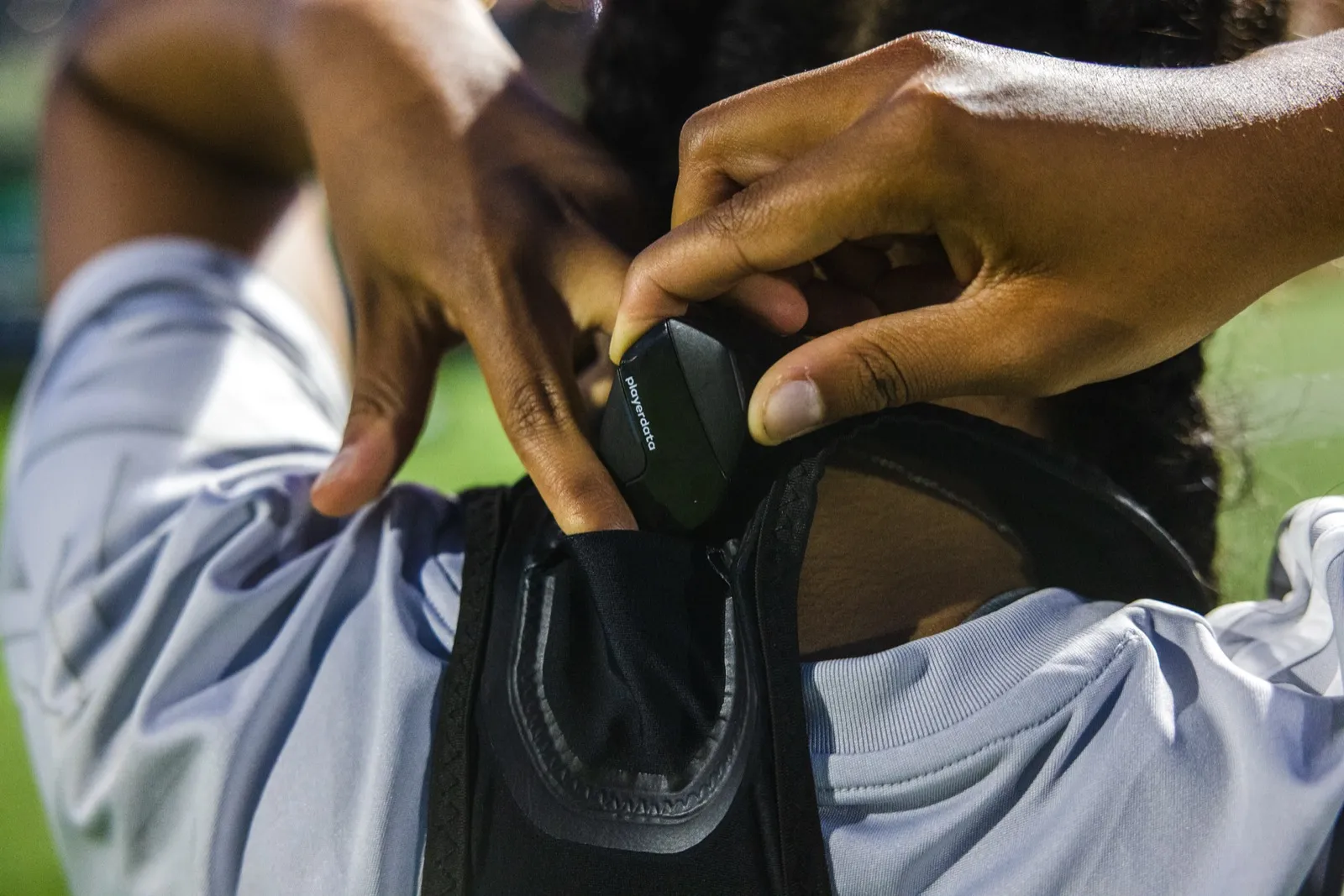 Fitting an EDGE Air unit into the pocket of a player's tracking vest