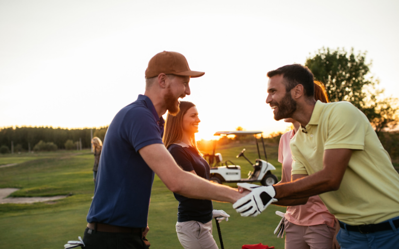 golfers shaking hands on golf course