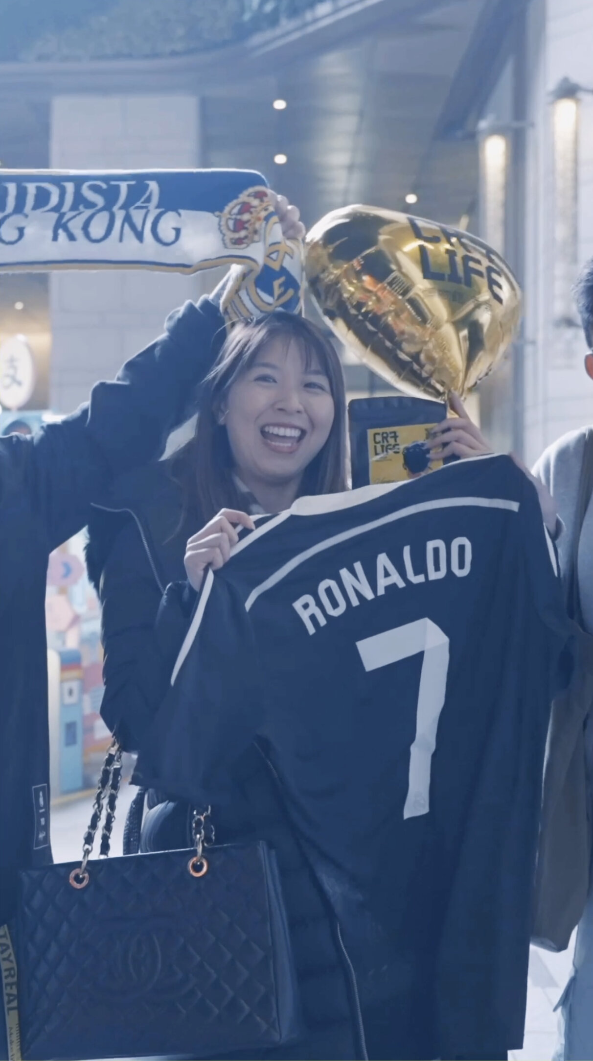 CR7 Life Museum — visitor in a Ronaldo shirt holding gold balloons in the Hong Kong exhibition