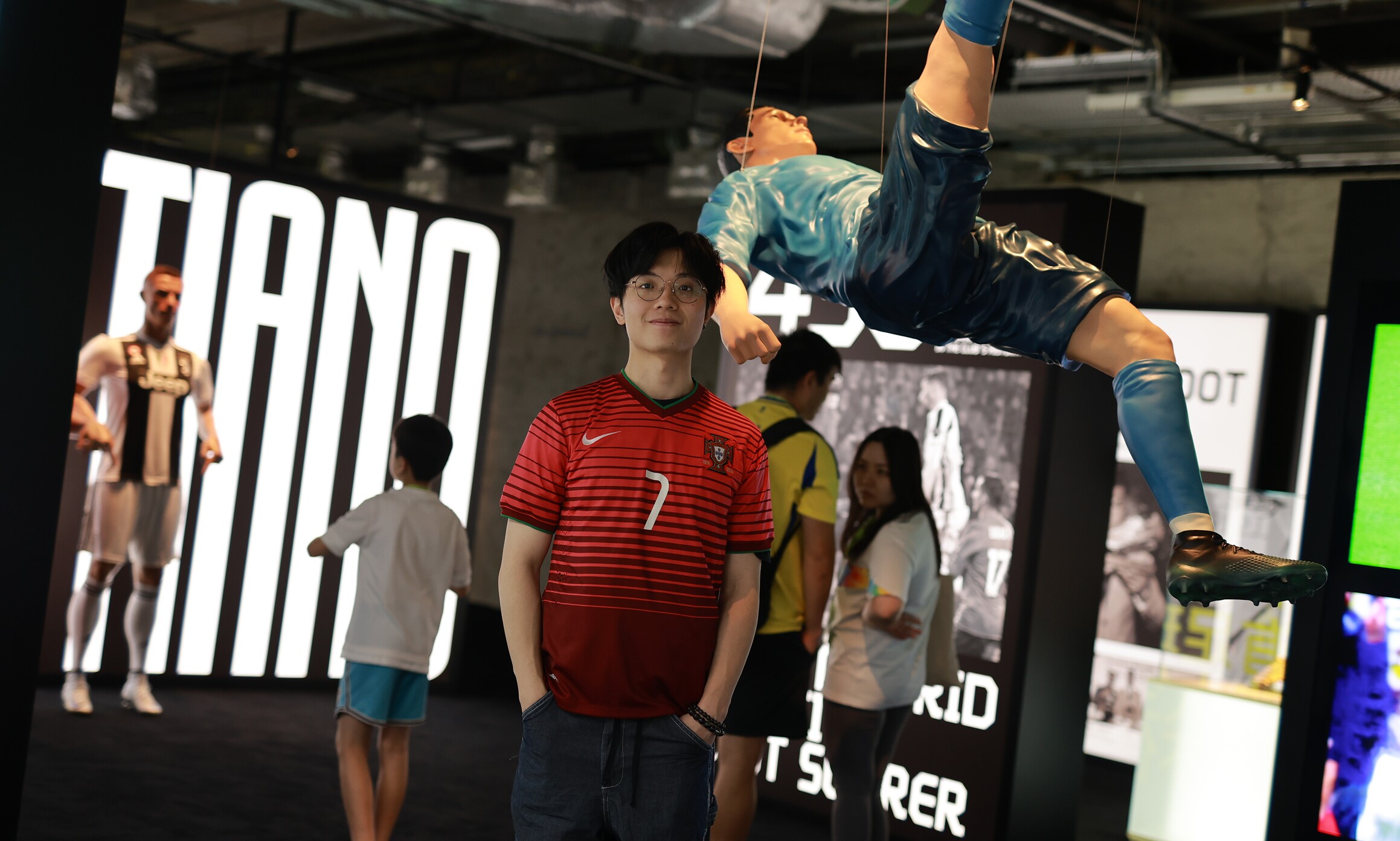 CR7 Life Museum — visitors beneath the suspended Ronaldo bicycle-kick figure