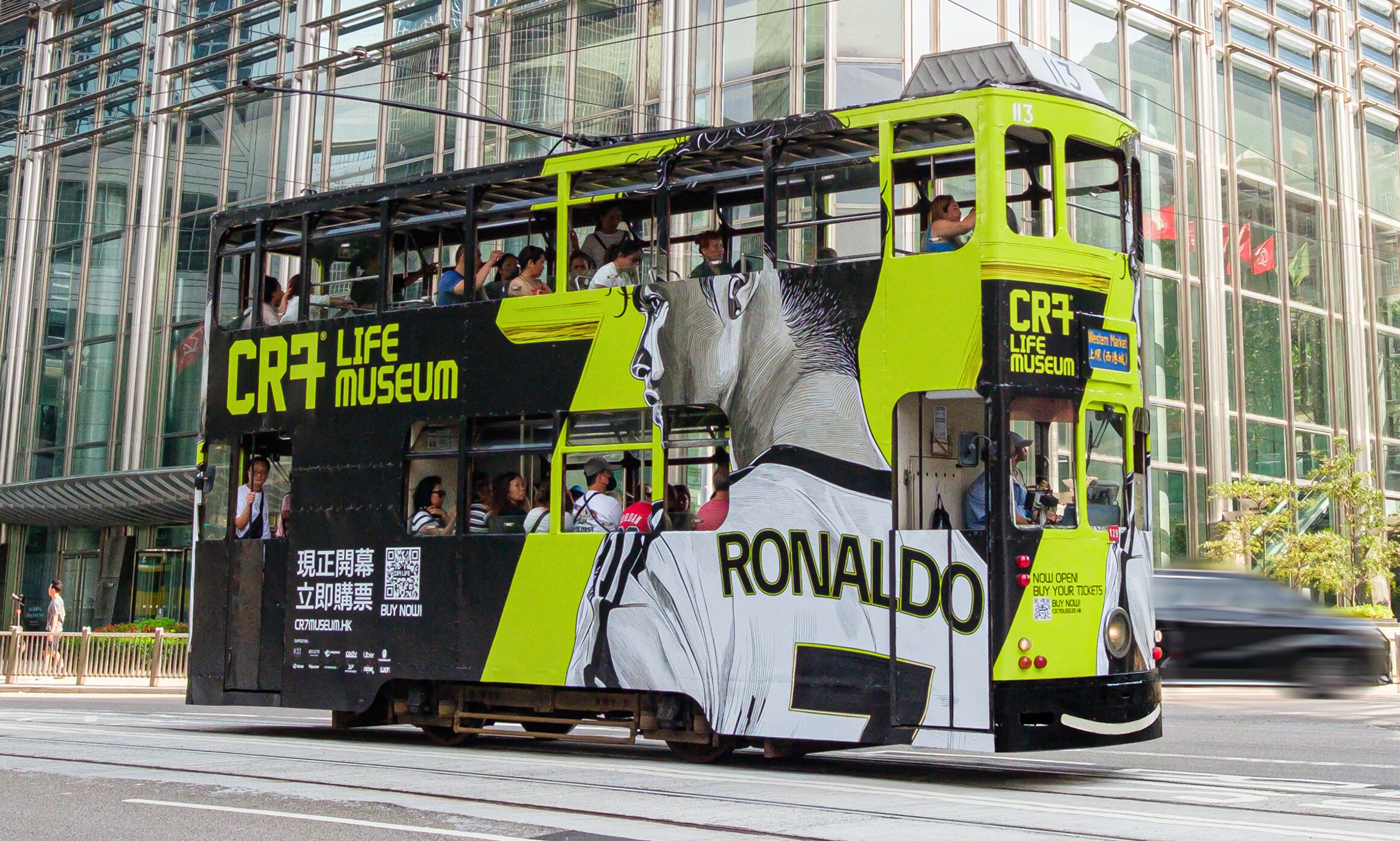 CR7 Life Museum — branded Hong Kong tram in the street outside a glass-fronted building