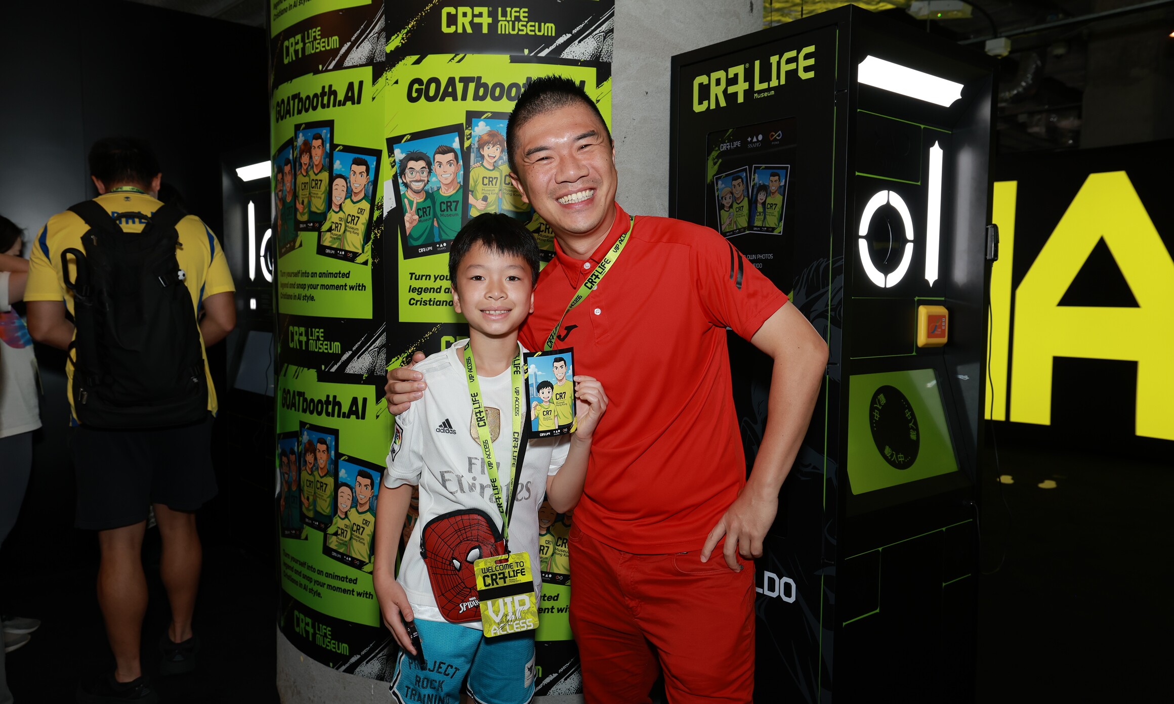 CR7 Life Museum — two visitors at the AI photo booth holding their printed portrait
