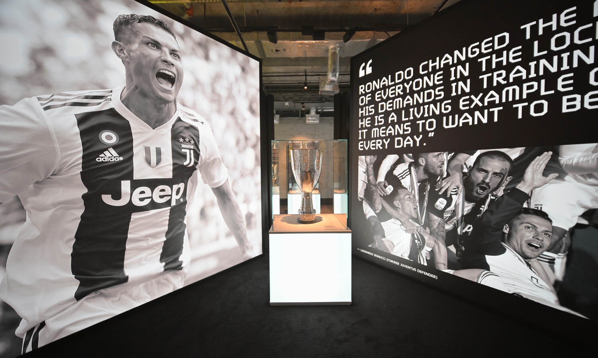 CR7 Life Museum — Juventus gallery with a trophy case and a monochrome Ronaldo portrait wall