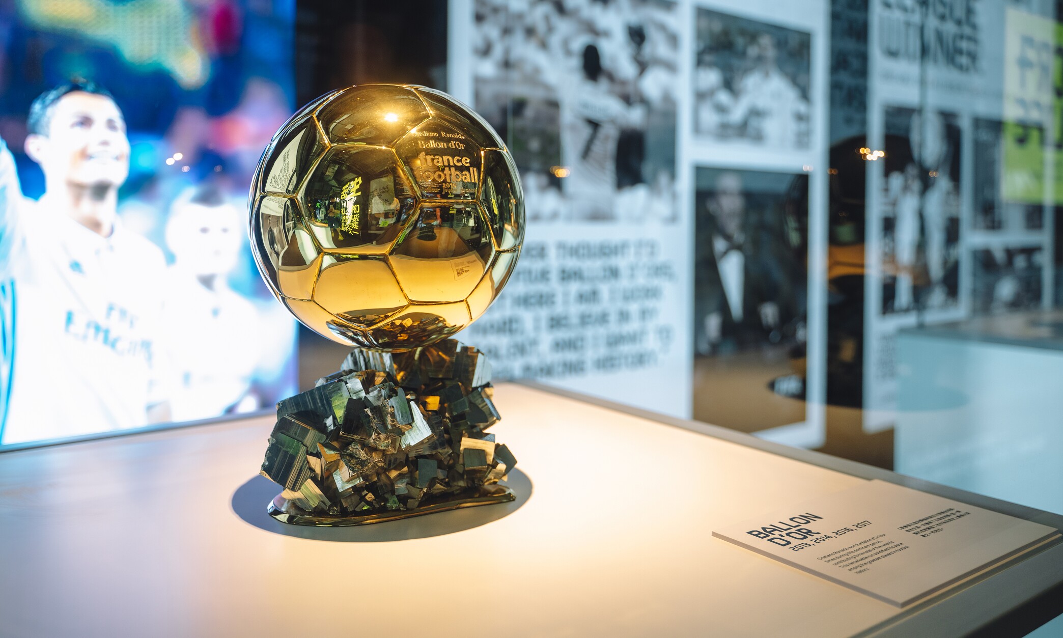 CR7 Life Museum — Ballon d'Or trophy displayed under spotlight in a glass case