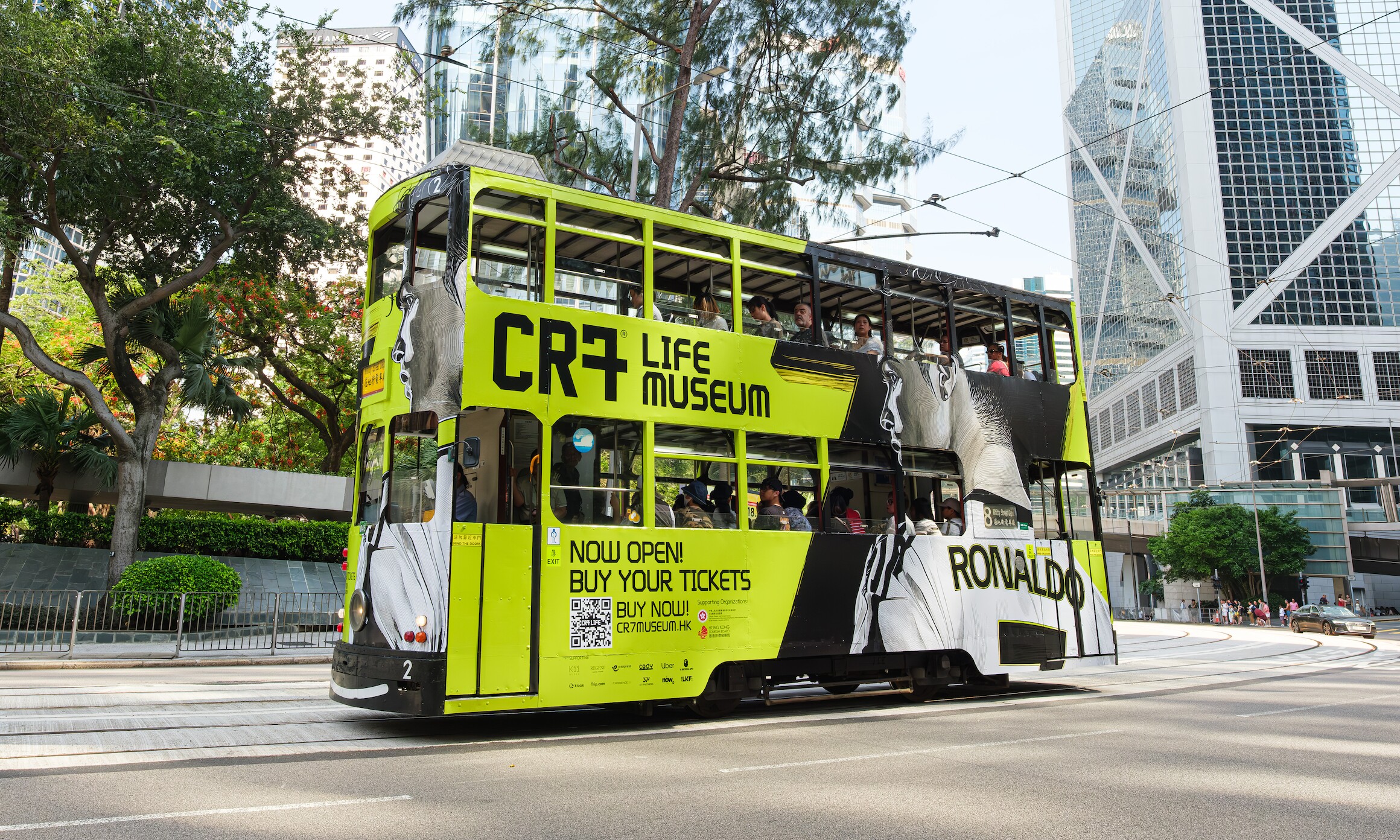 CR7 Life Museum — branded Hong Kong tram passing the Bank of China tower in Central