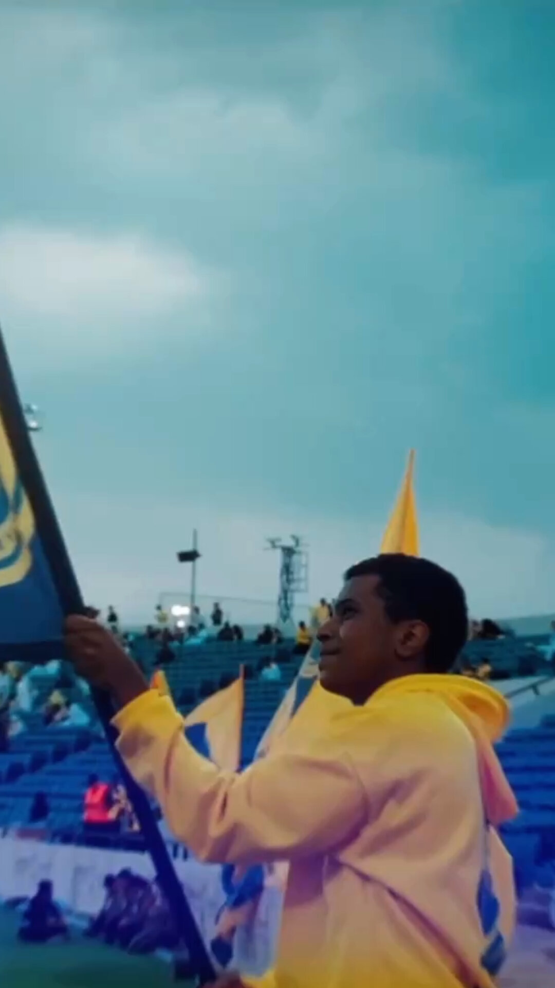 Al Nassr — supporter waving the club flag in the stadium