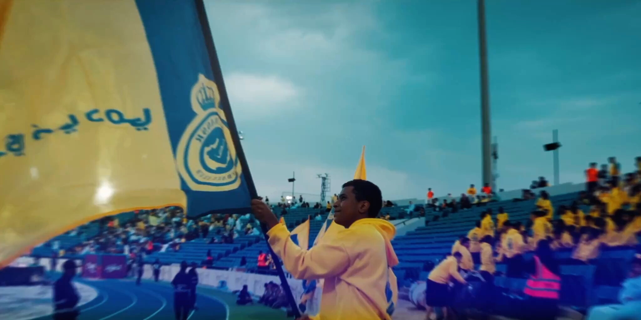 Al Nassr — supporter waving the club flag in the stadium