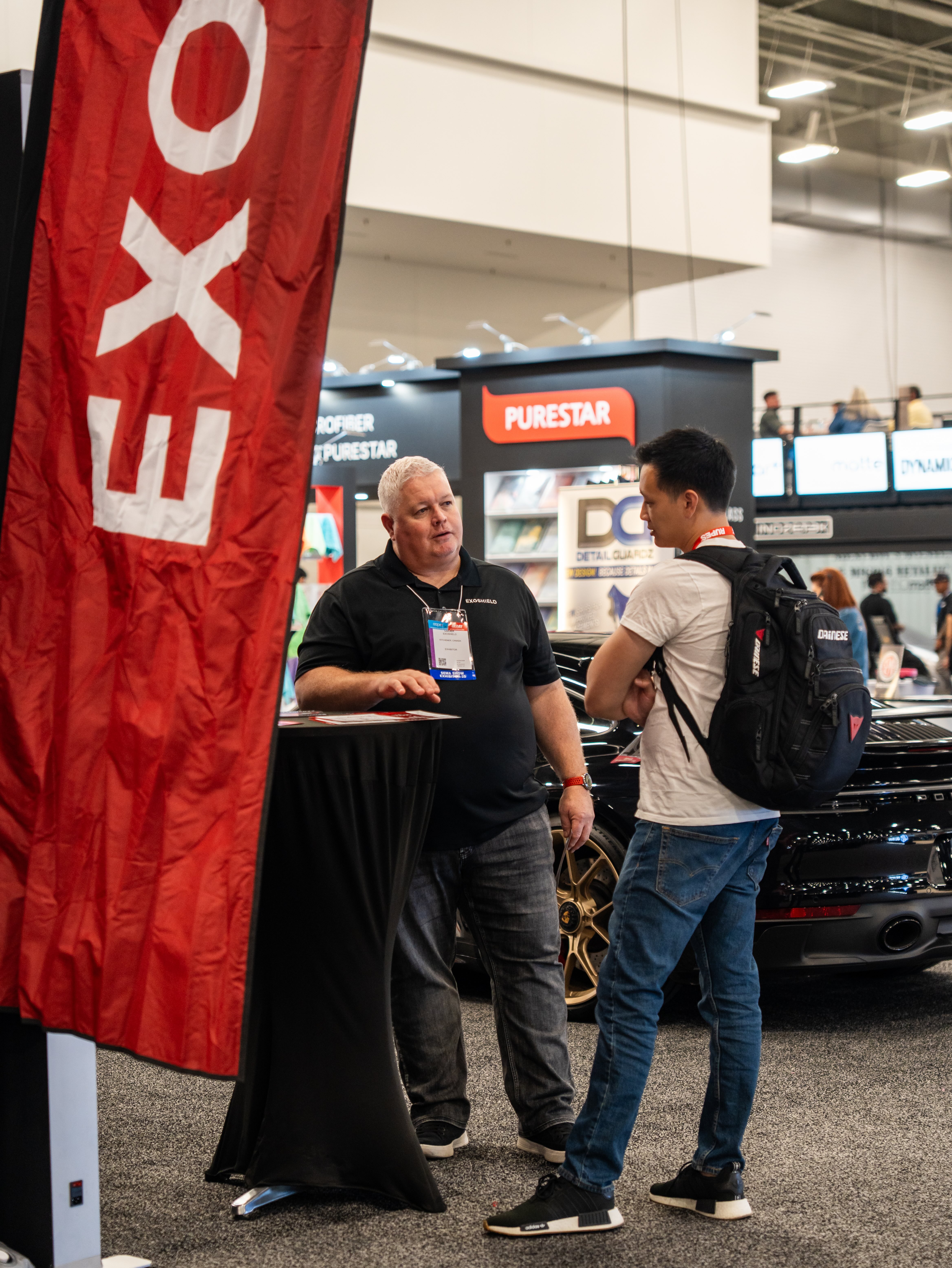 ExoShield employee talking about windshield protection film at SEMA 2025
