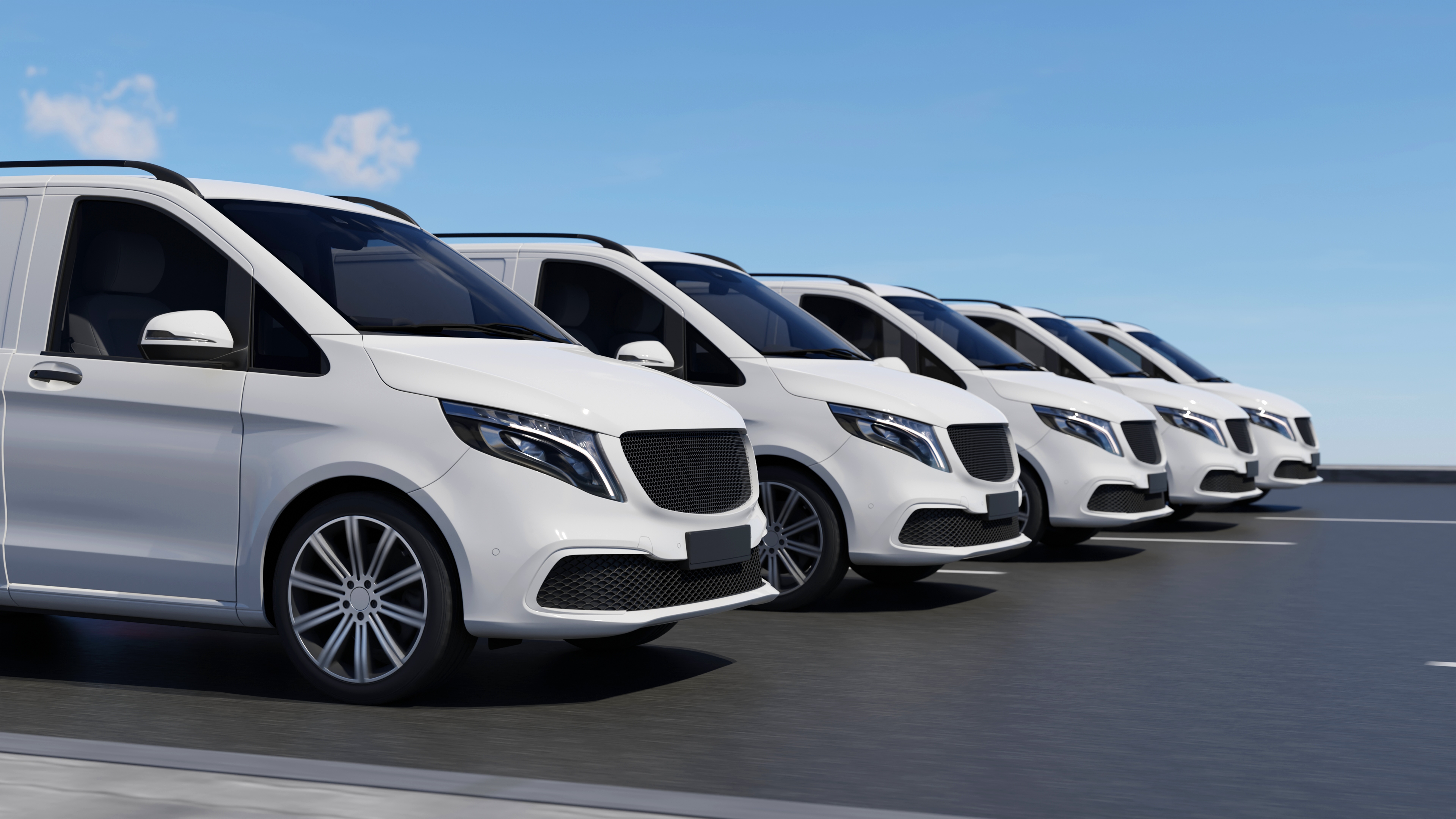 Parking lot filled with white fleet vehicles