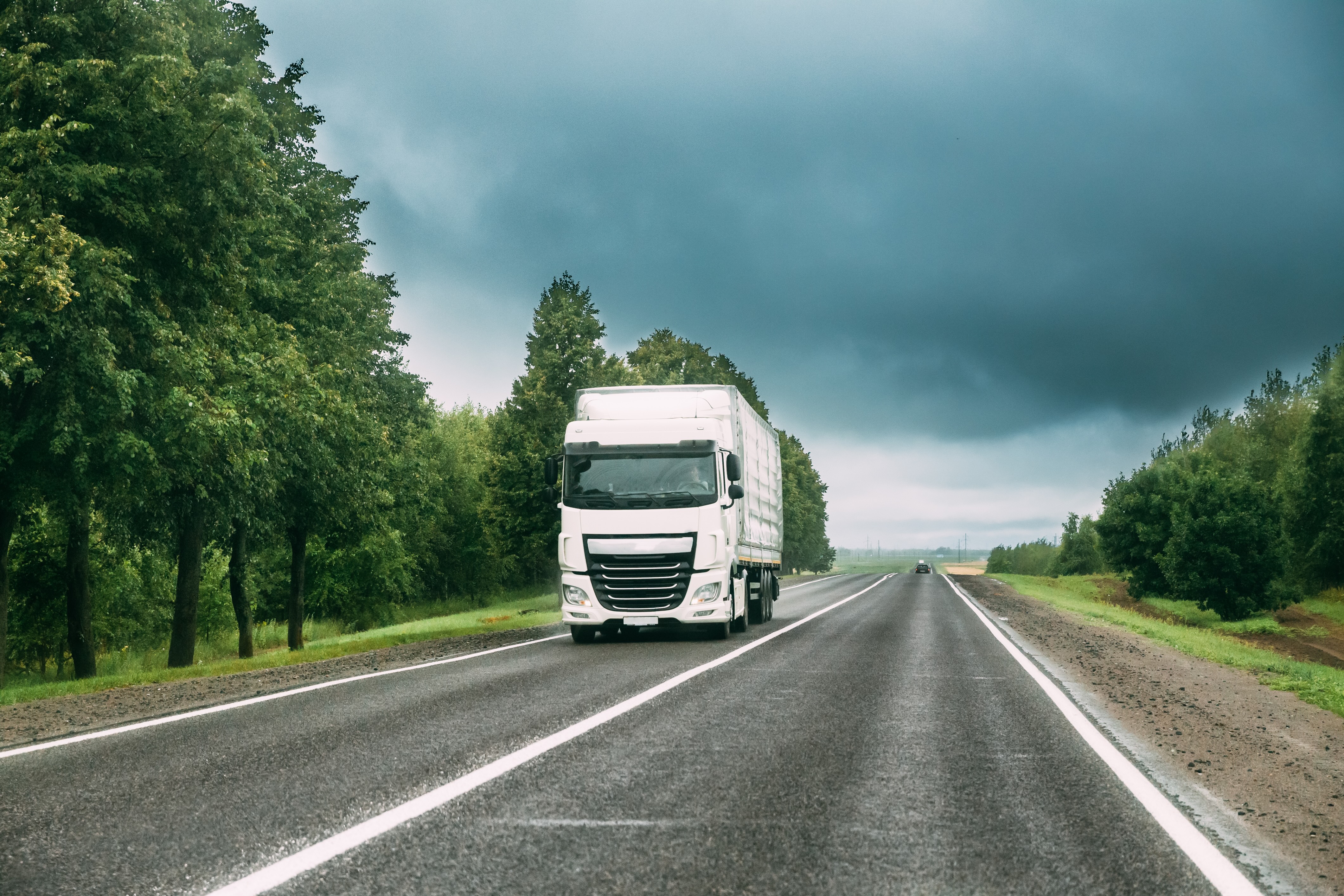 Transport truck driving down a one lane highway.