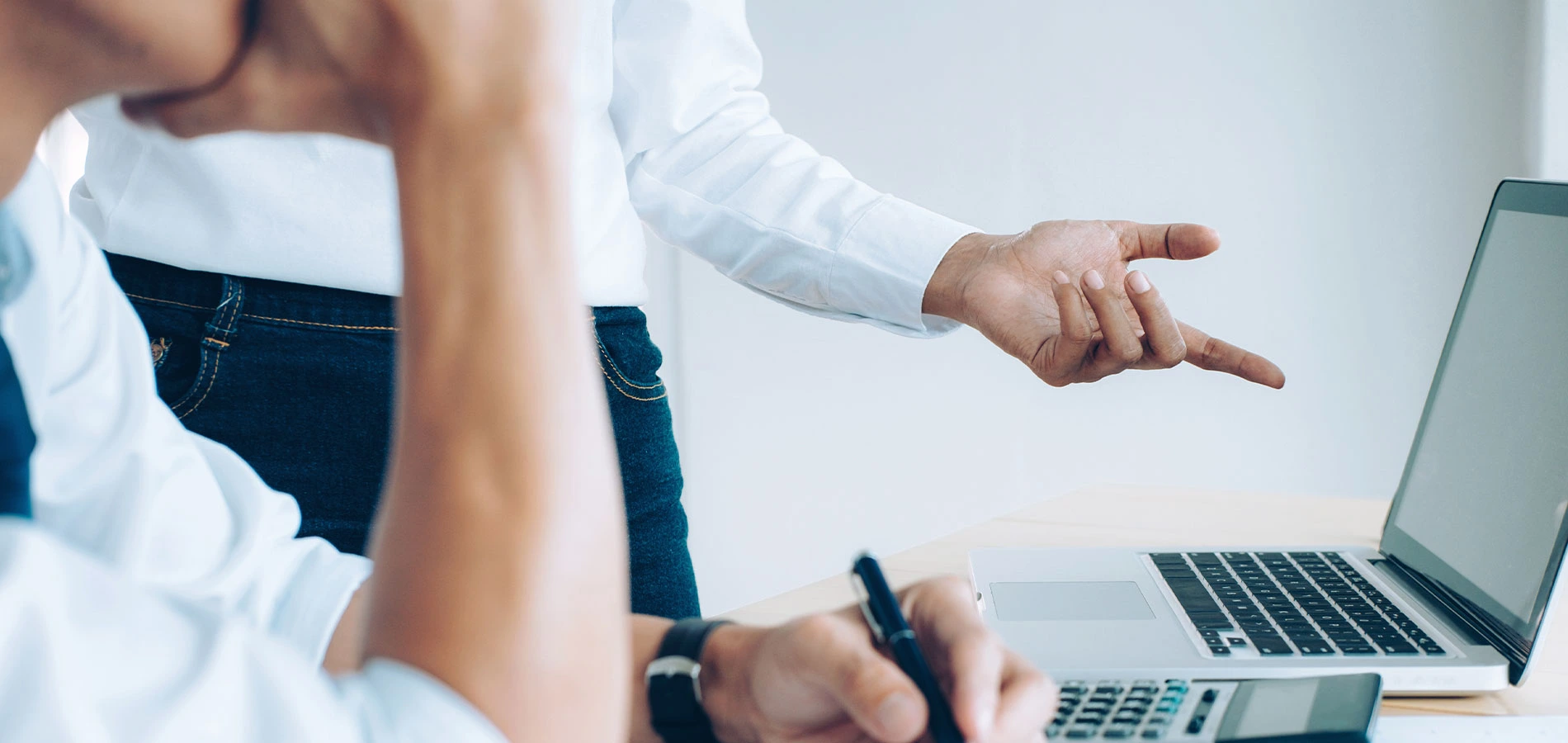 Two people discussing using a laptop