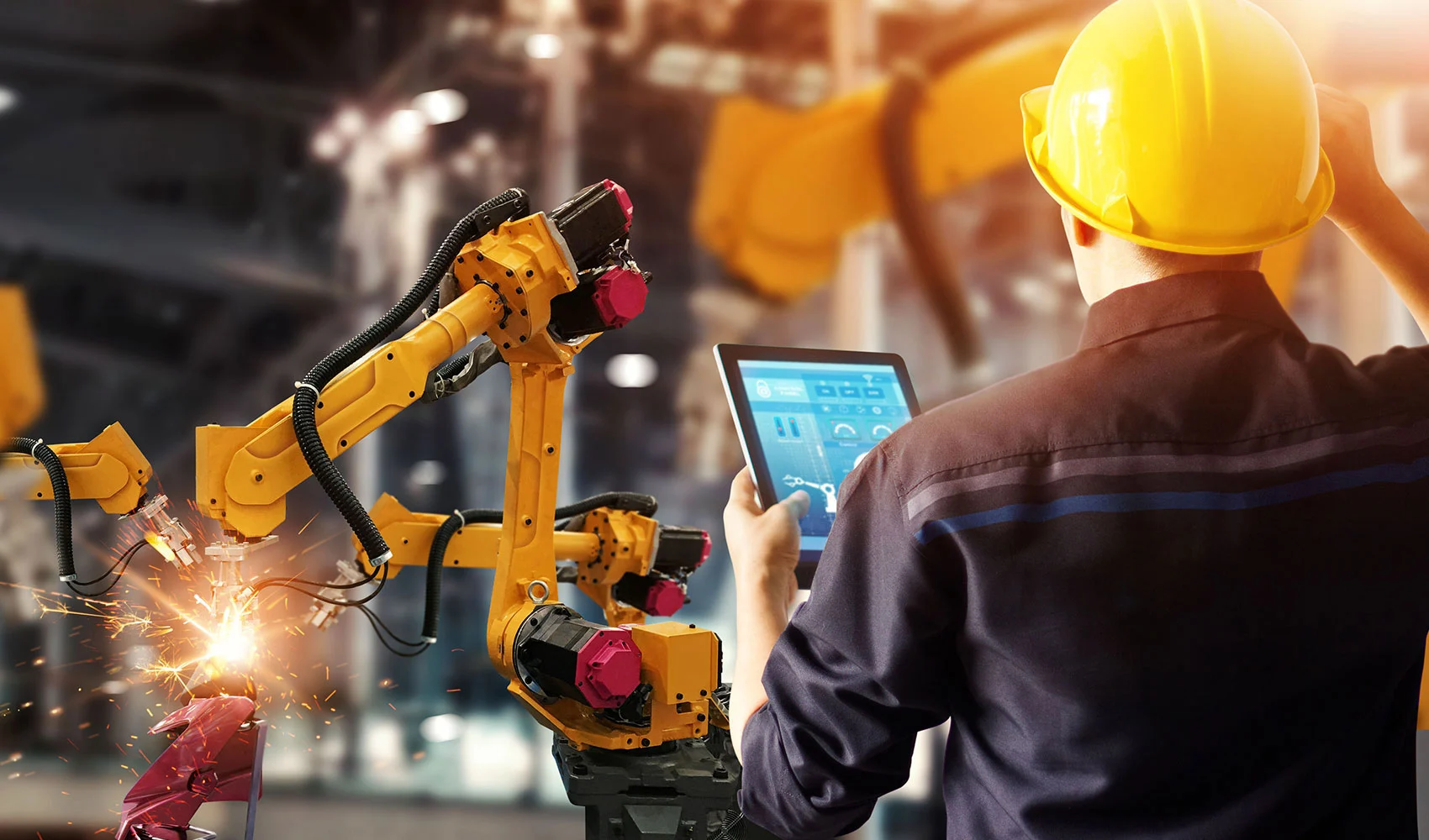 Engineer checking welding automatic arms machine