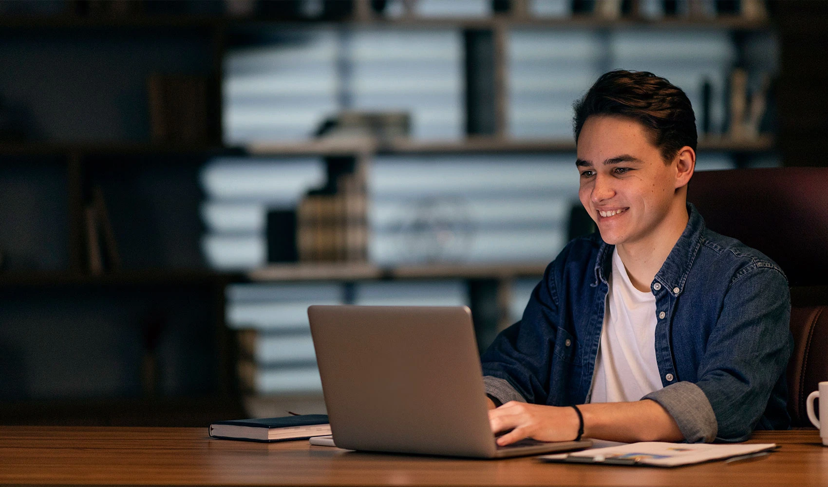 Young guy working with his laptop at night
