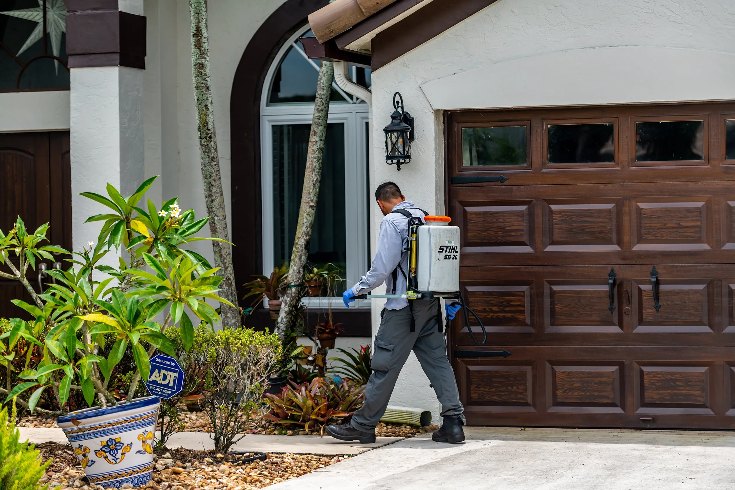 man spraying the house