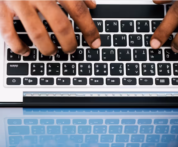Hands typing on a keyboard