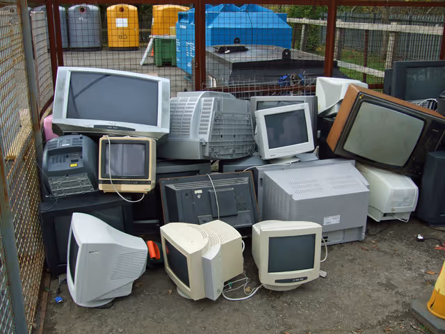 televisions and computers inside of a cage