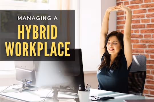 Managing a Hybrid Workplace - Woman stretching in front of her computer