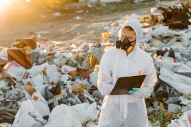 Man walking on a e-waste landfill