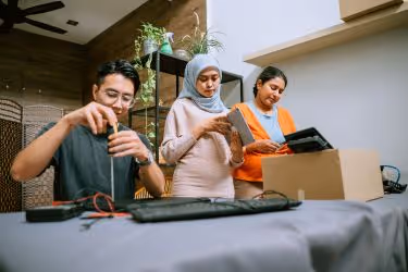 Group of employees learning on how to recycle electronics