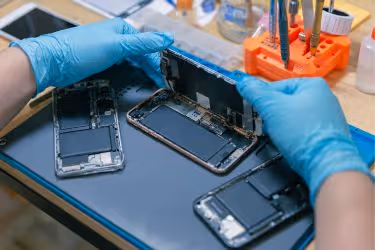 Person repairing a mobile phone