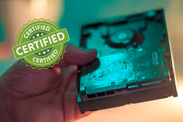 Hand holding a hard disc and a seal that says "certified"