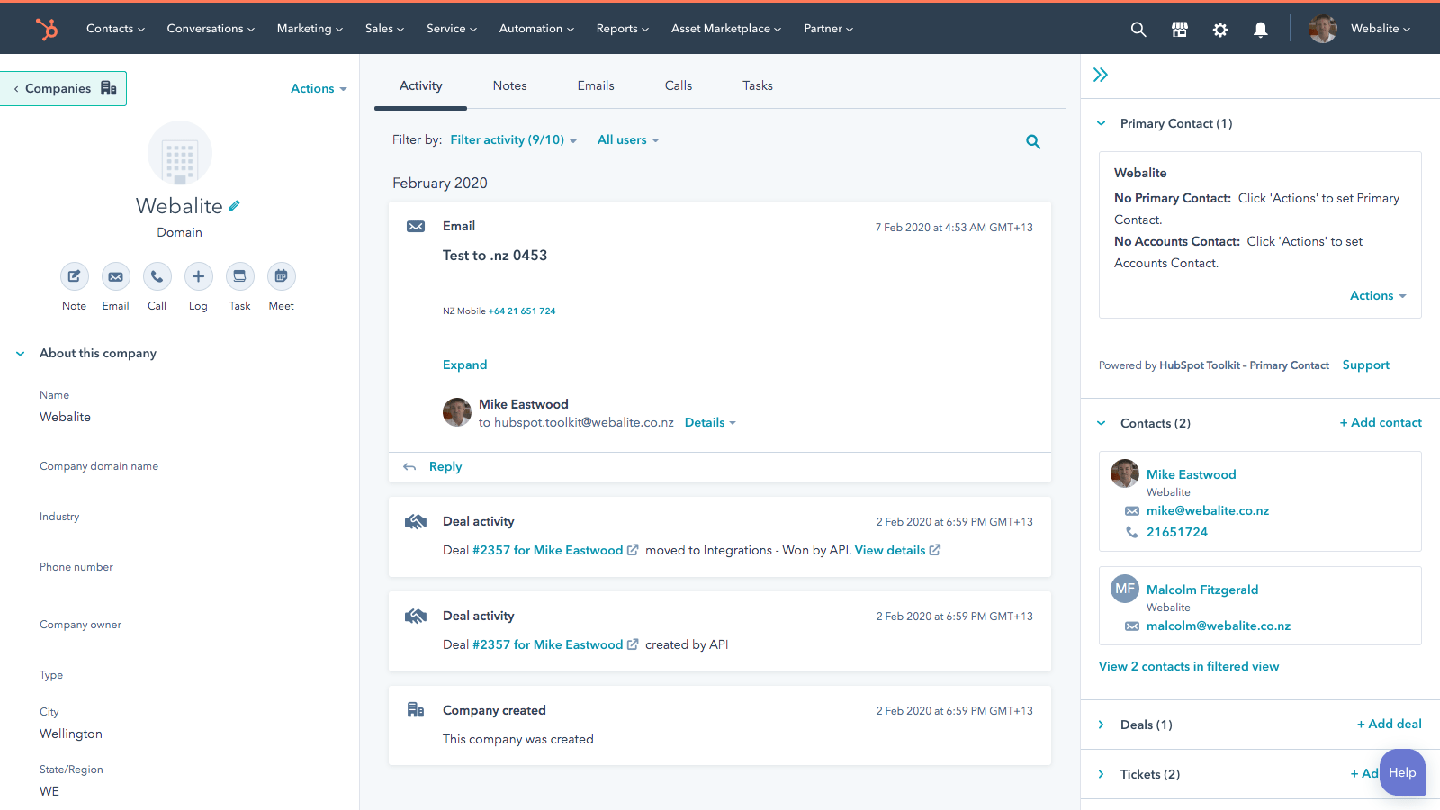 Screenshot of the HubSpot CRM company record for “Webalite,” featuring the activity timeline with recent emails and deal updates, primary contacts panel, contact list, and main navigation for contacts, marketing, sales, and reports.