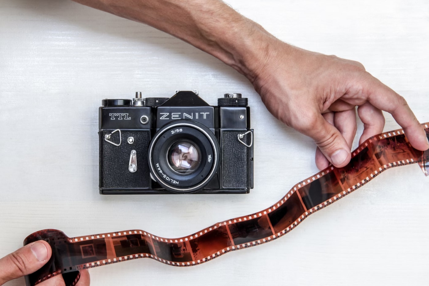 A camera is shown next to a reel of film.