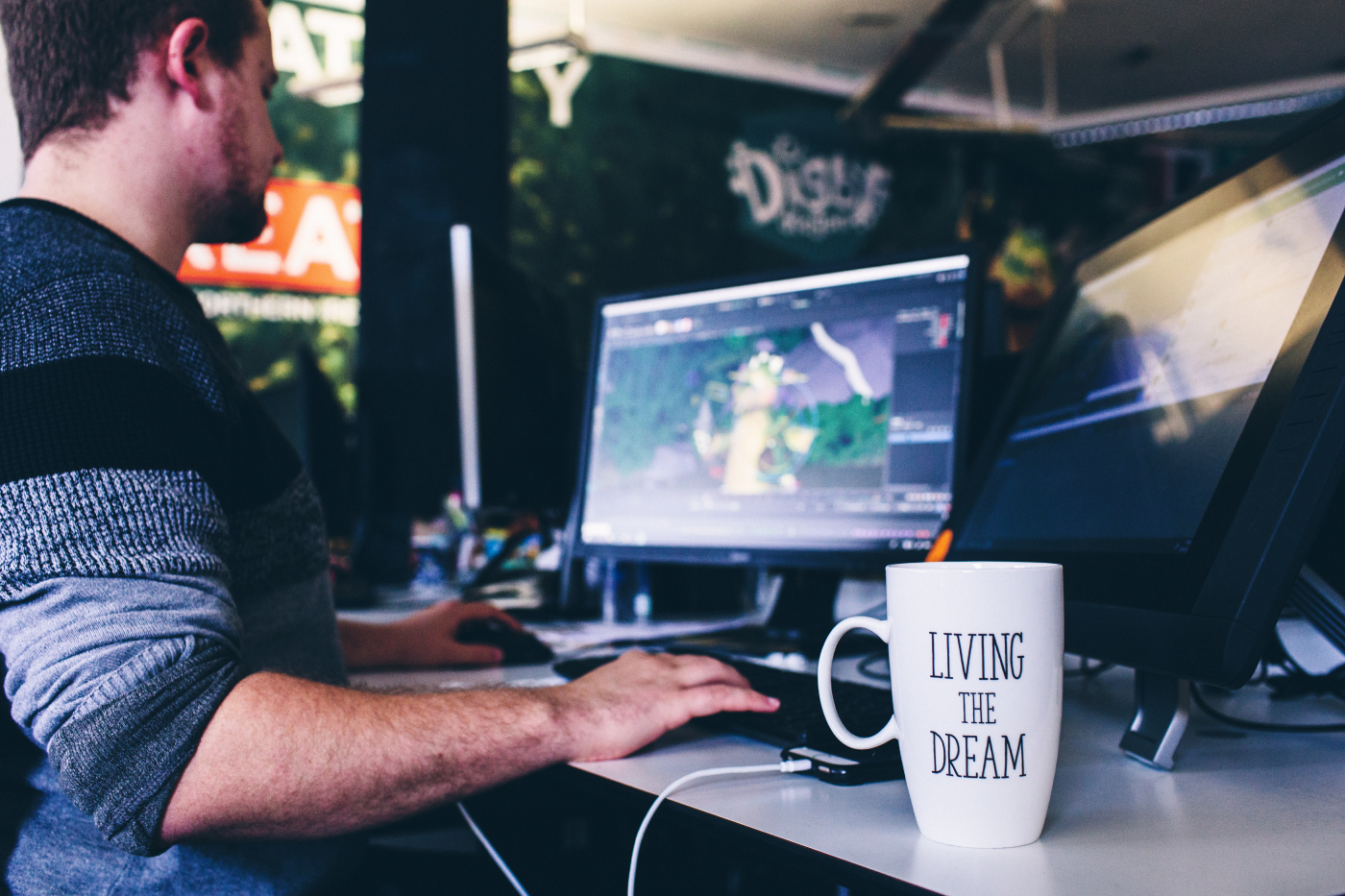 White male animator working at a desk in a creative studio