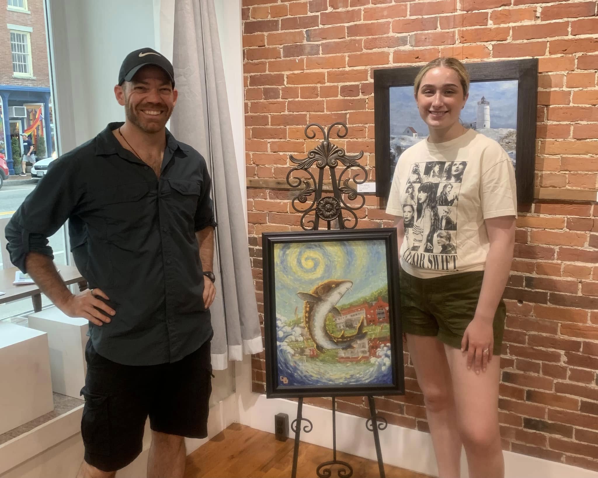 Art raffle winner Anna Pellerin with artist Christopher Blanchard and his painting, Uplifting