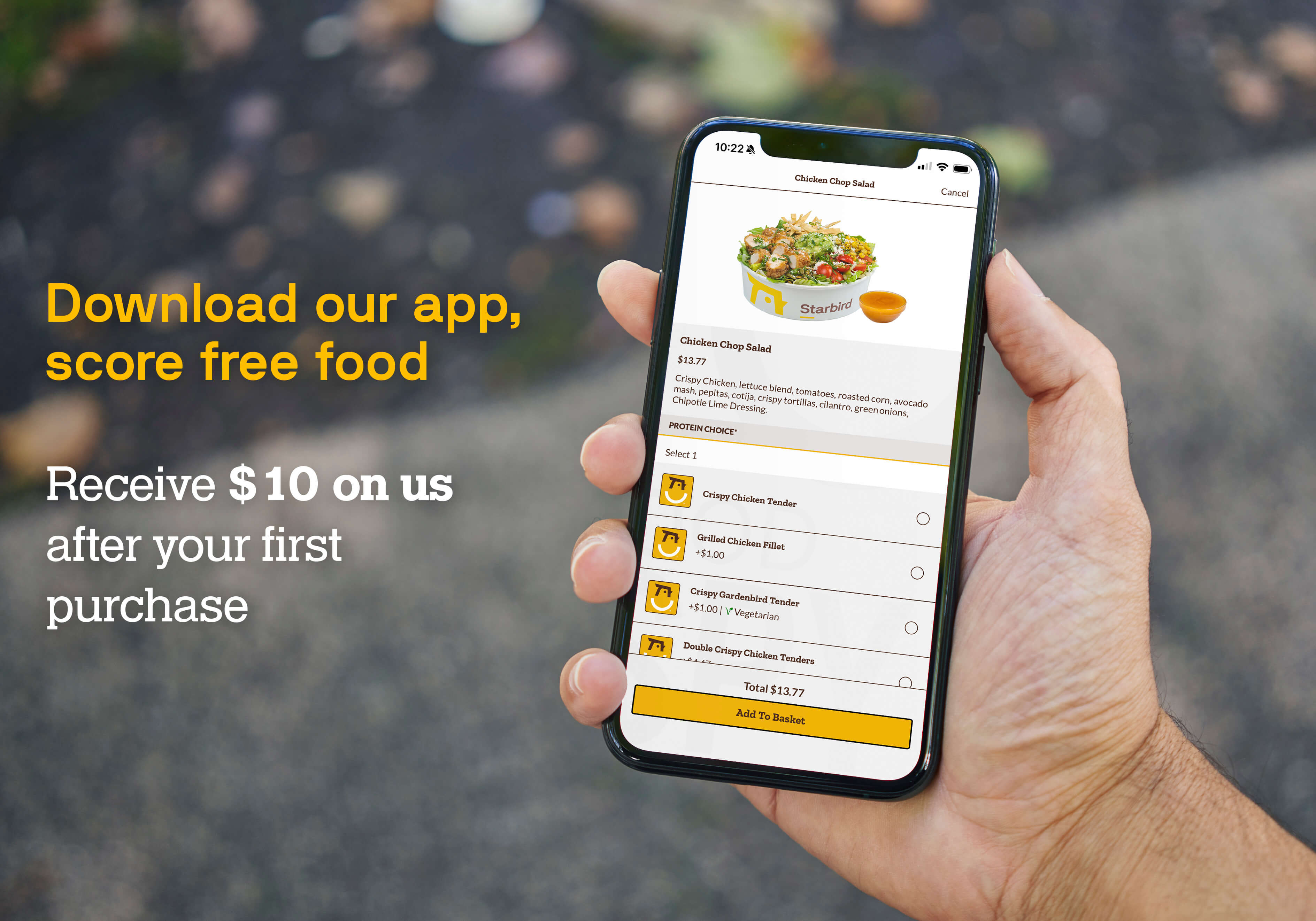 Hand holding a phone showing an ordering screen on the Starbird Chicken app