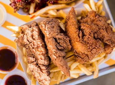 Platter of chicken tenders with accompanying dipping sauces.