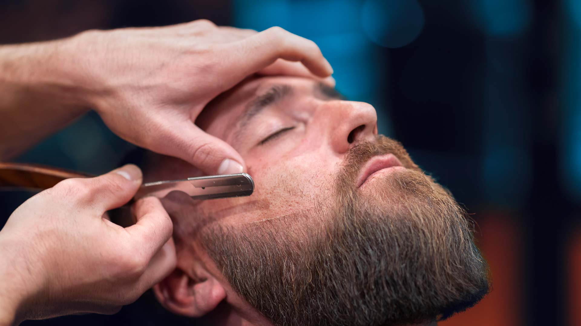 Man getting straight razor shave