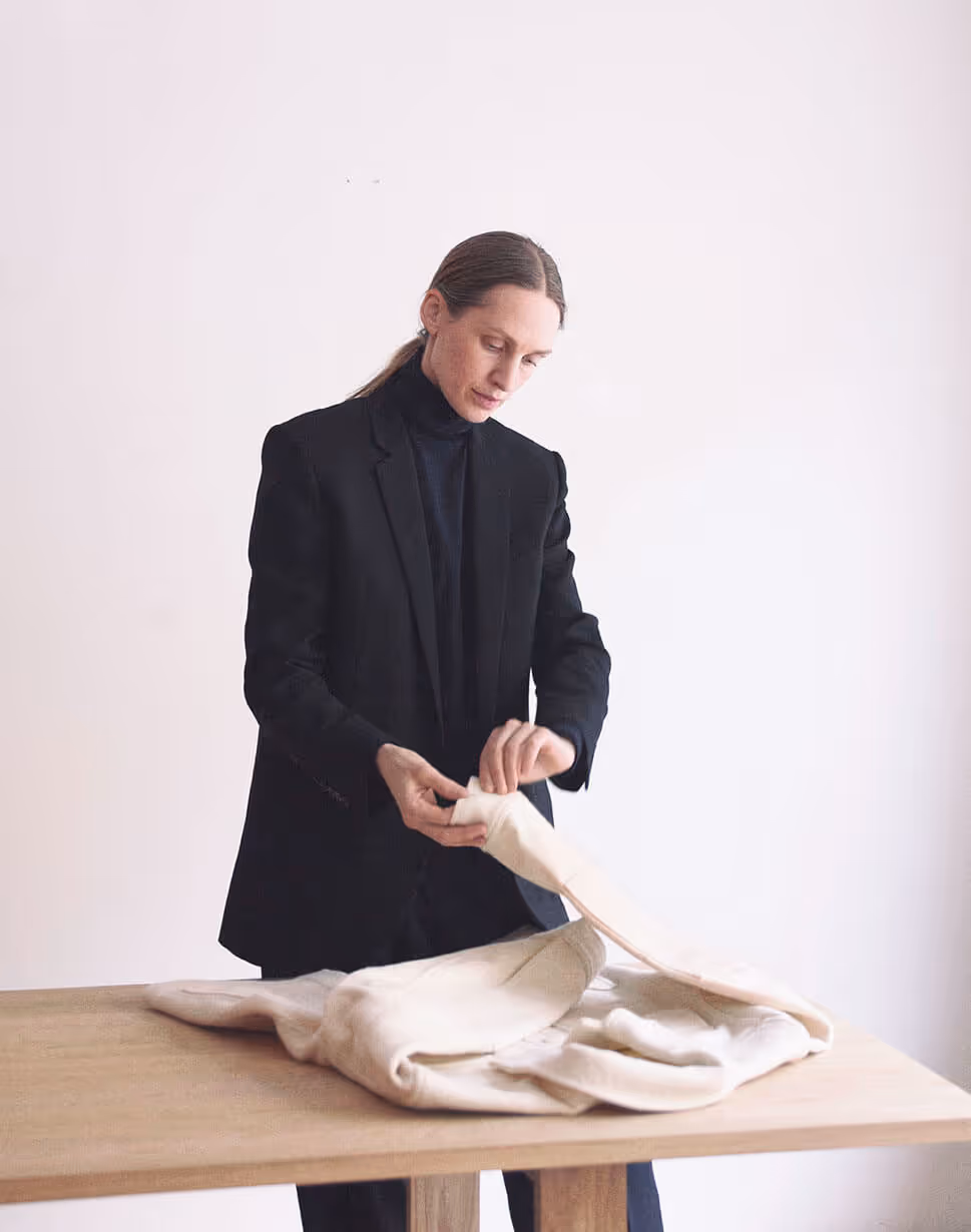 A sustainability consultant inspects a jacket
