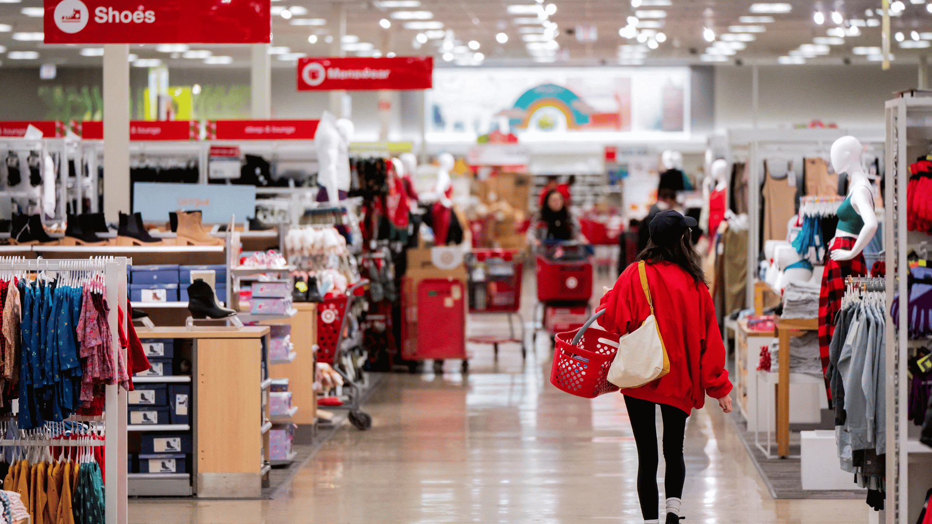 Shoppers walking down an aisle at a Target store