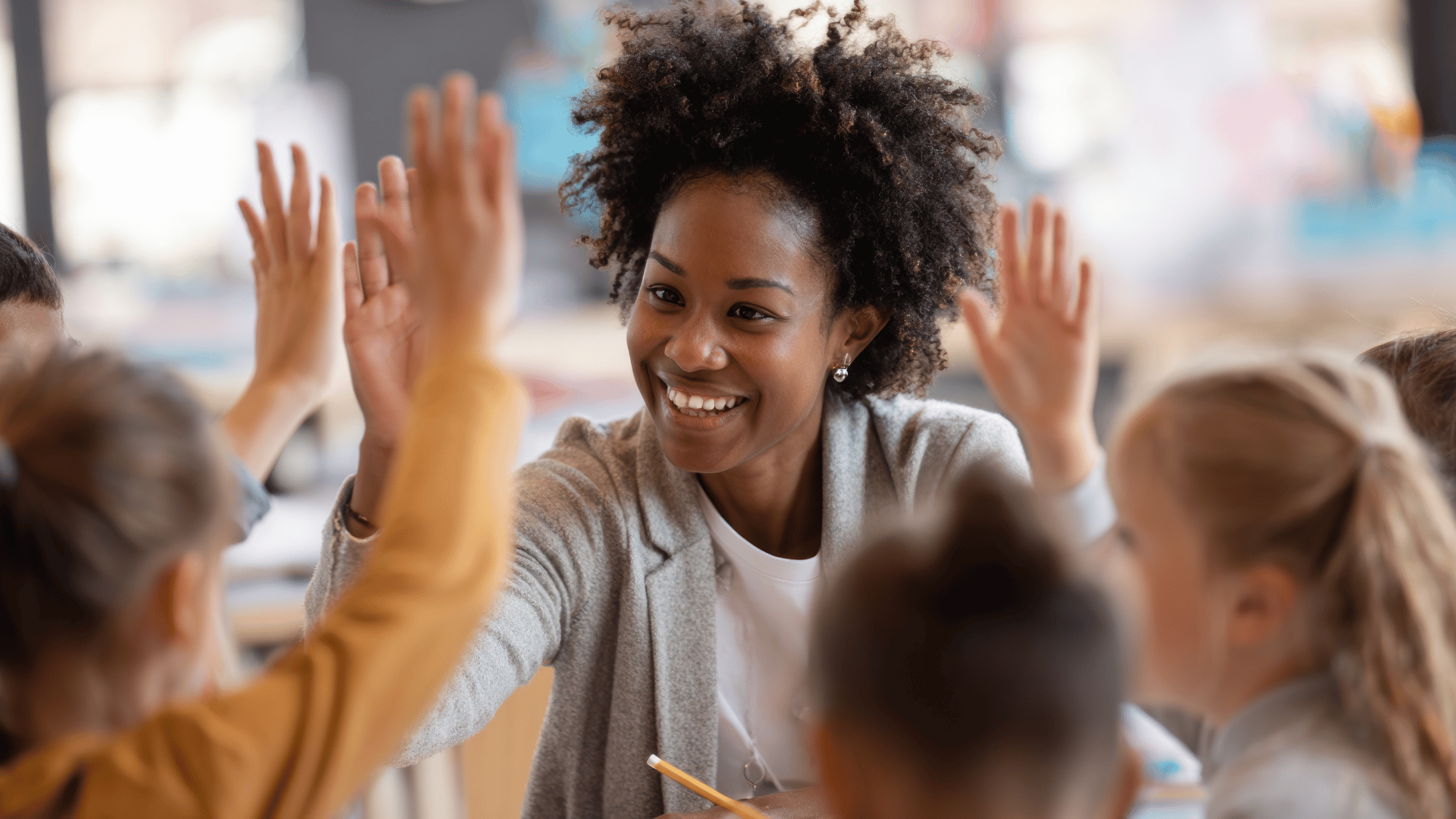 Teacher high-fiving students