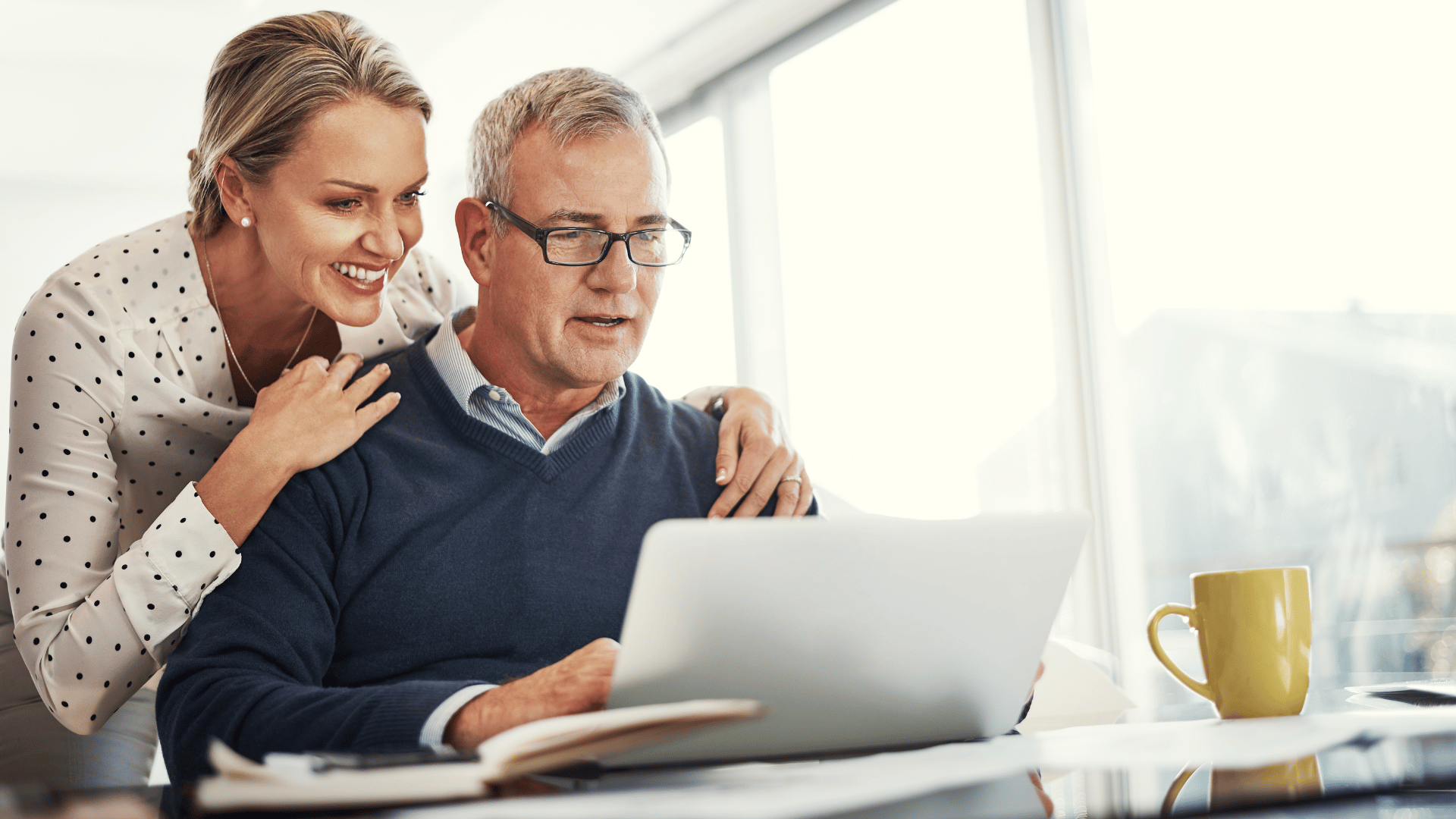 Middle-aged couple looking at a computer