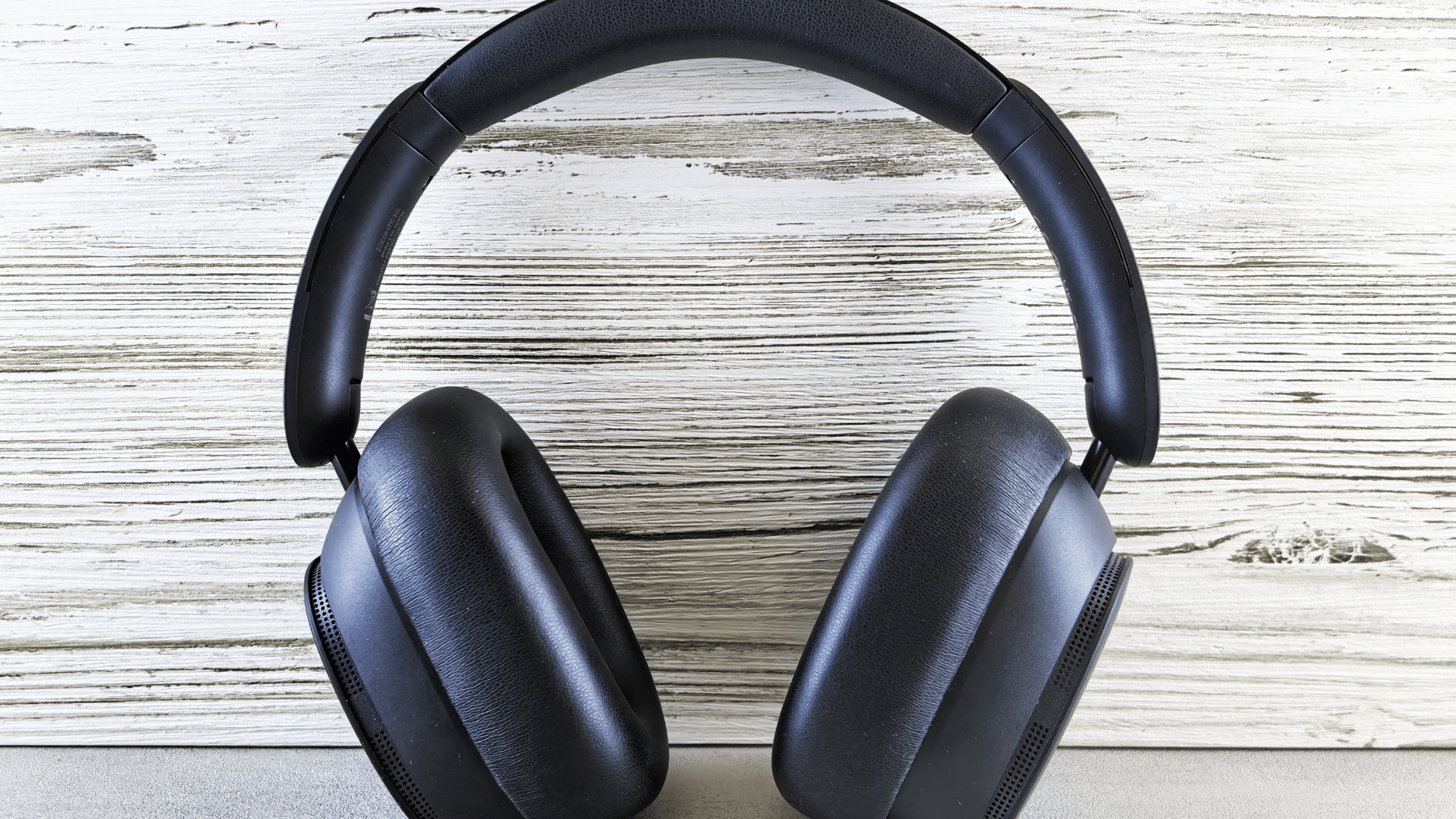 headphones in front of a wood grain background