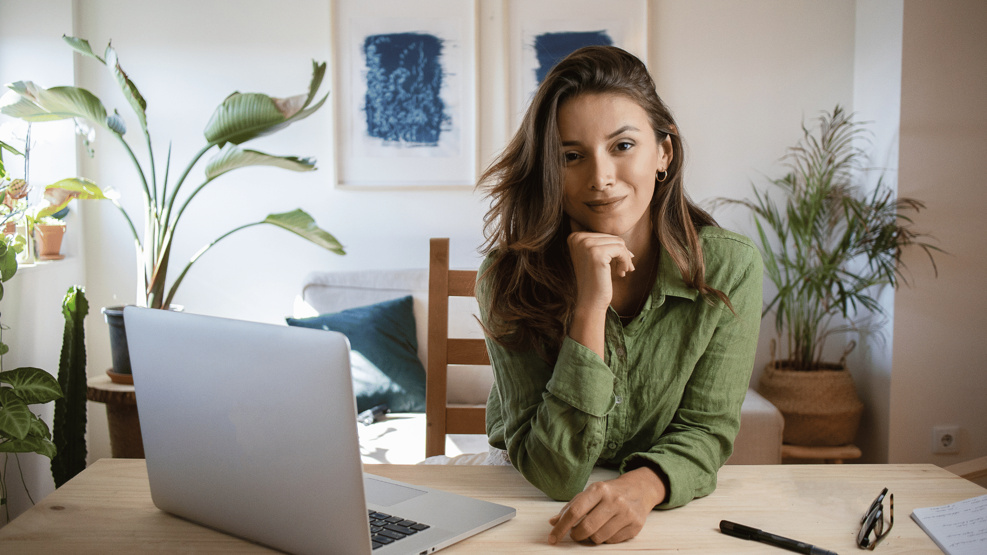 Woman at the home office with a laptop on her desk