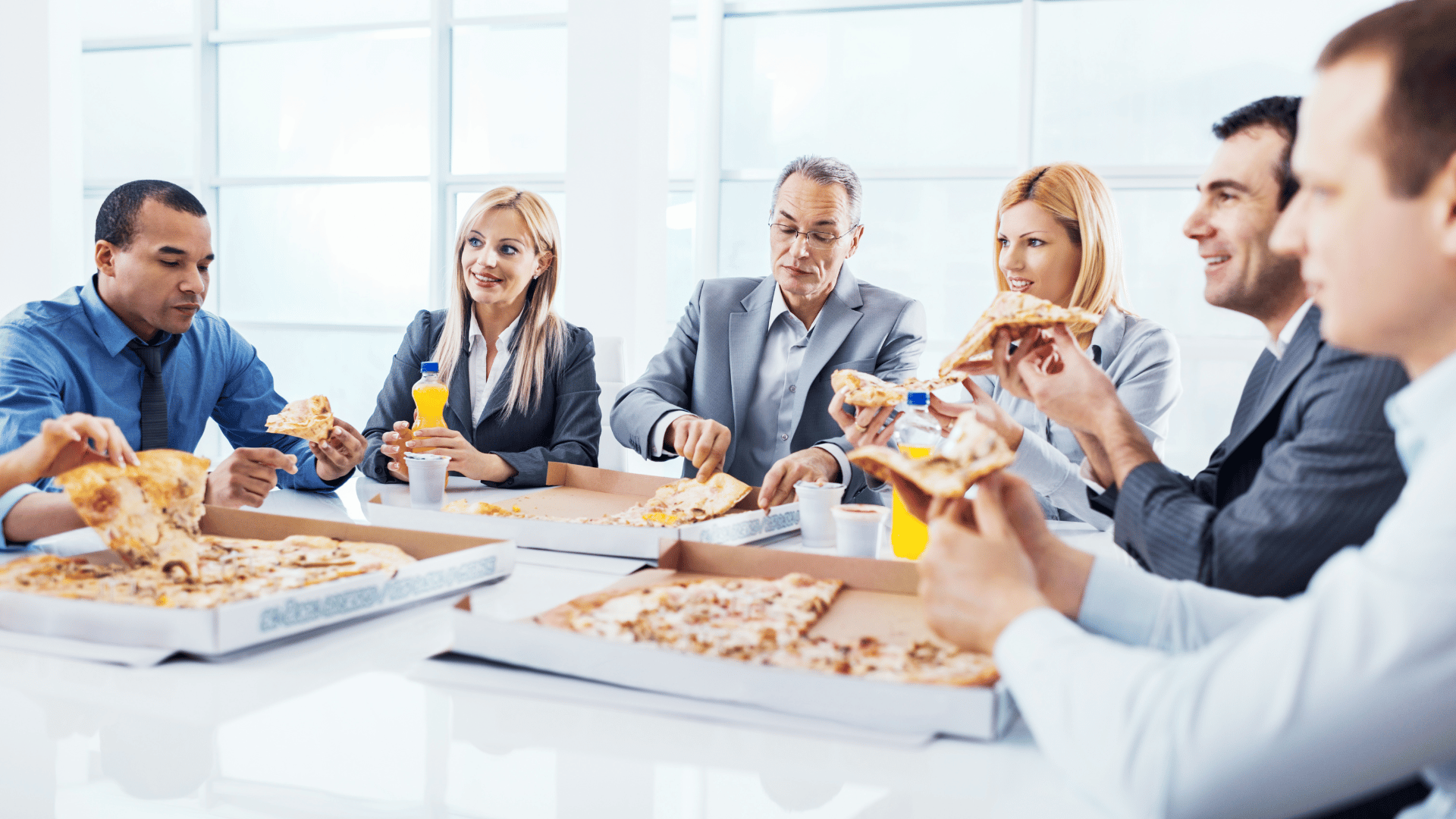 Office workers having a pizza lunch