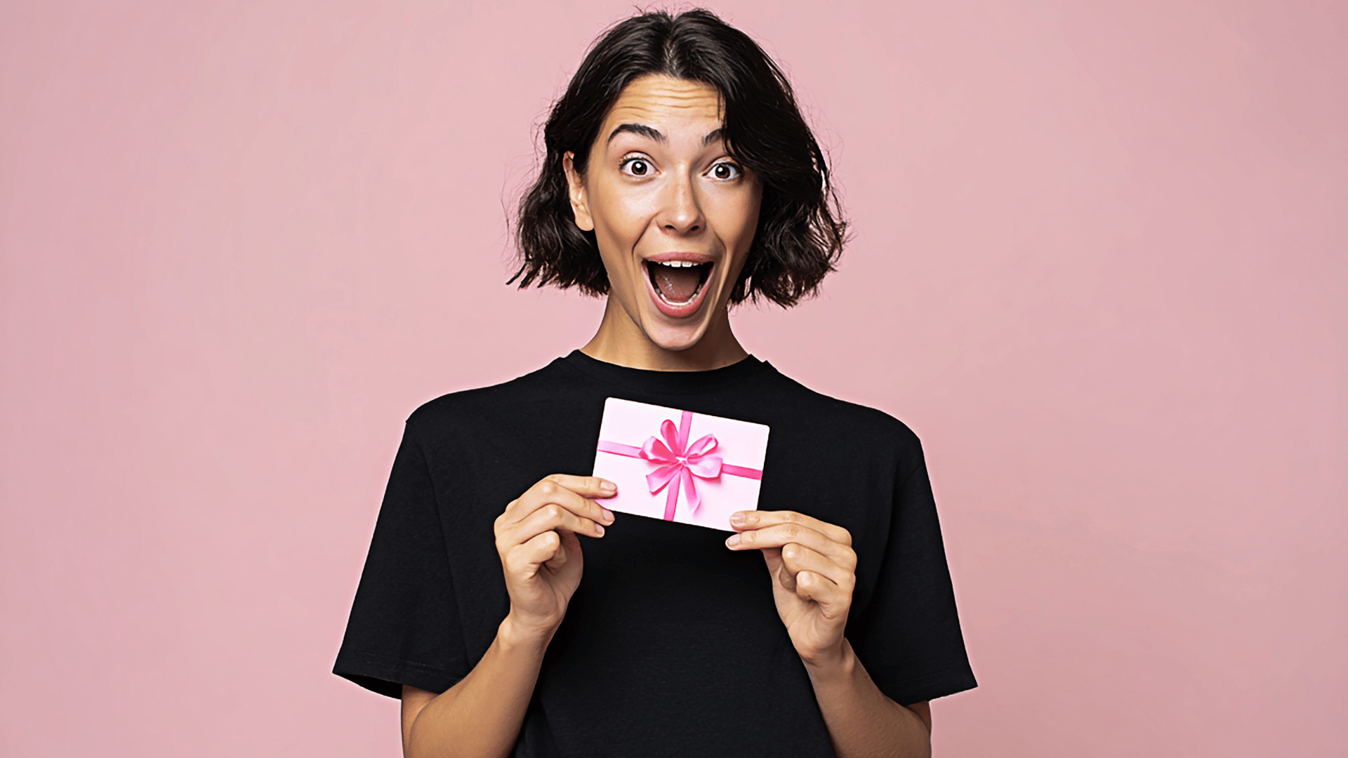 Excited woman holding a gift card