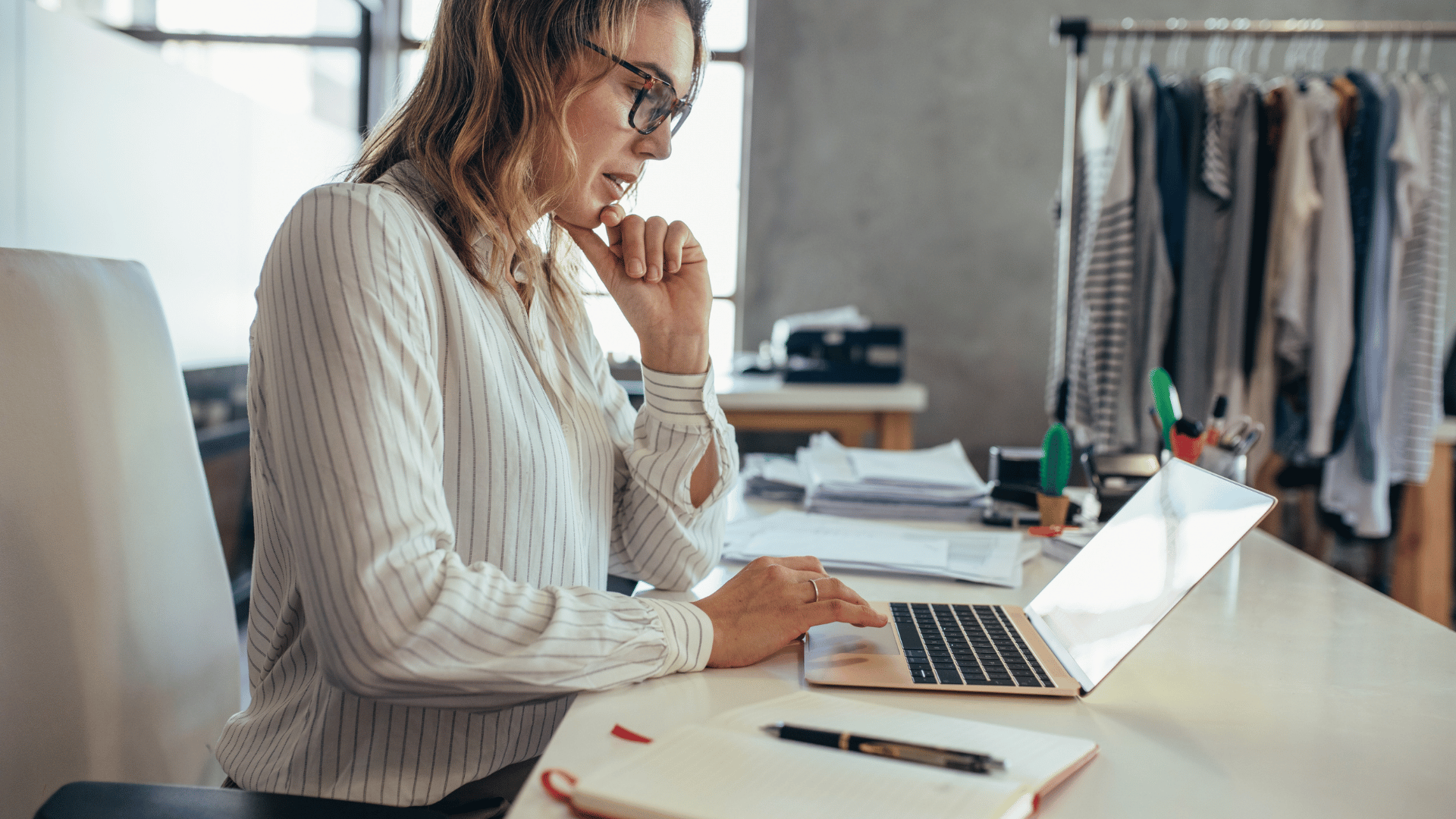 Woman sitting at a desk using her laptop