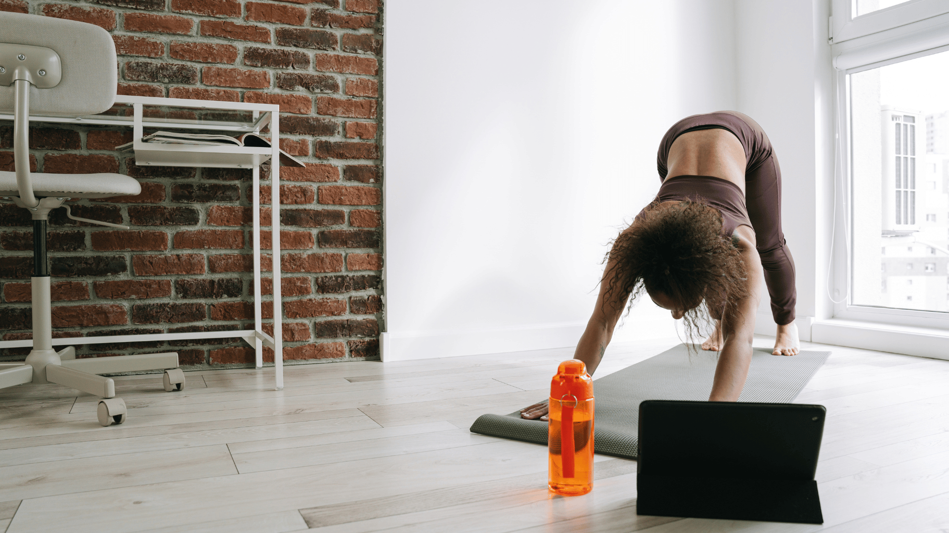 Woman practicing virtual yoga in the office