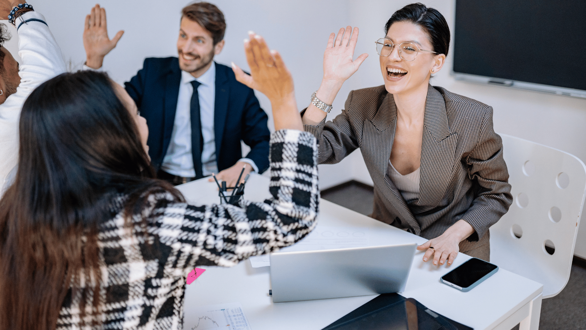 Employees high-five in the office